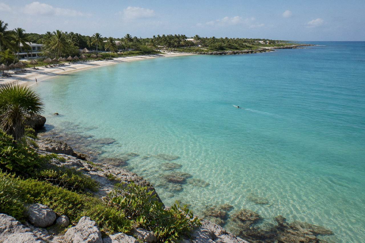 Calm turquoise water and sandy bottom seen from above in a quiet tropical bay