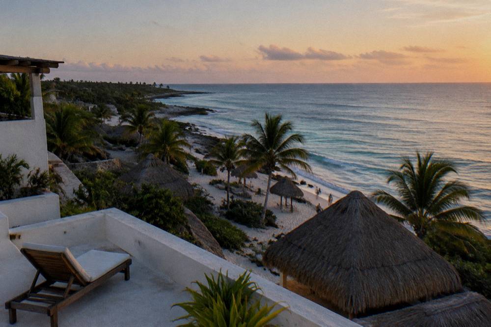 A calm sandy beach at early morning with soft light over gentle waves and palm trees